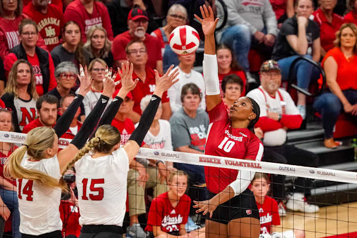 Oct 21, 2023; Lincoln, NE, USA; Wisconsin Badgers middle blocker Devyn Robinson (10) attacks against Nebraska Cornhuskers outside hitter Ally Batenhorst (14) and middle blocker Andi Jackson (15) during the second set. Mandatory Credit: Dylan Widger-USA TODAY Sports
